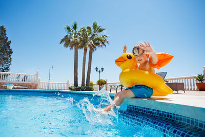 Rear view of woman swimming in pool