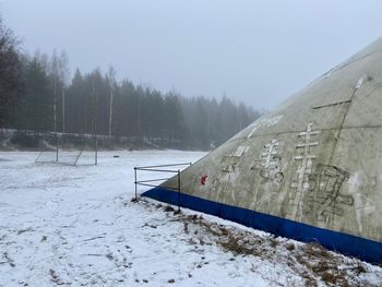 Scenic view of snow covered field against sky