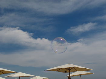 Low angle view of bubbles against sky