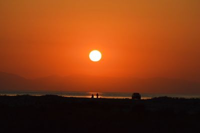 Scenic view of sea against orange sky during sunset