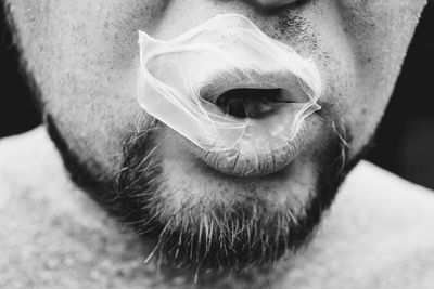 Close-up of mid adult man blowing bubble gum