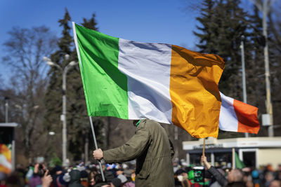 Protester holding irish flag on street