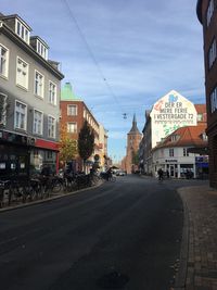 City street and buildings against sky