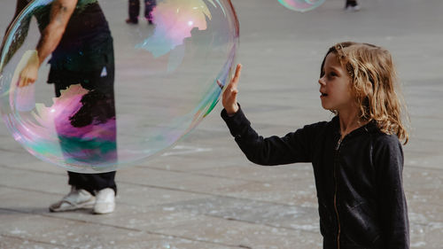 Full length of woman holding bubbles