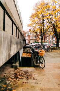 Bicycle parked on footpath by buildings in city