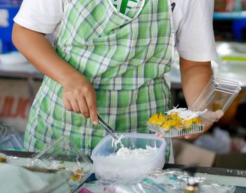 Midsection of man preparing food