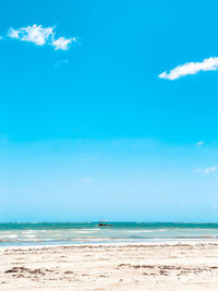 Scenic view of sea against blue sky