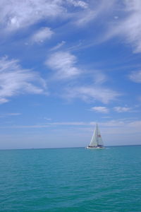 Sailboat sailing in sea against sky