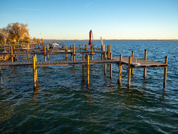 Pier on sea against clear sky