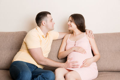 Young couple sitting on sofa