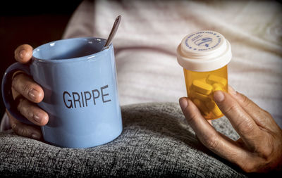 Midsection of person holding coffee cup