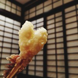 Close-up of ice cream on window at home