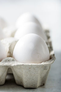 Close-up of eggs in carton on table