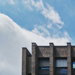 Low angle view of building against cloudy sky