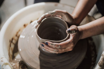 Close-up of artist making pot at workshop