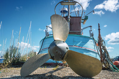 Low angle view of ship on beach against sky