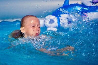 Boy swimming in pool