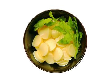 High angle view of vegetables in bowl against white background