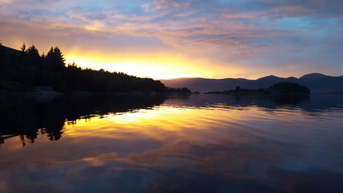 Scenic view of lake against romantic sky at sunset