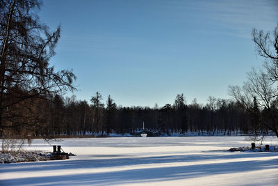 Snow covered field against sky