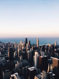 Aerial view of buildings in city against clear sky