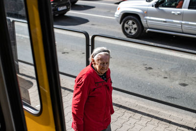 Portrait of man standing in car