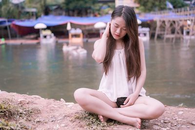 Young woman sitting in lake