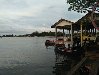 Boat in river against sky