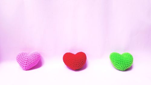 Close-up of heart shape over pink background