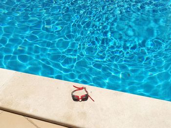 High angle view of swimming goggles on poolside