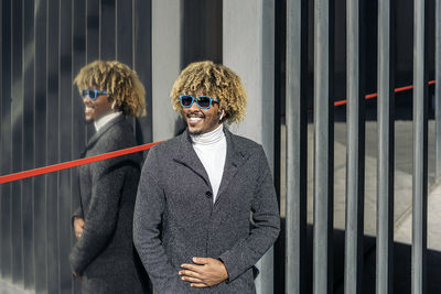 Portrait of young man wearing sunglasses standing outdoors