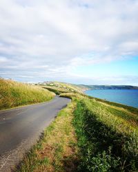 Road by sea against sky
