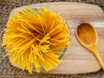 Directly above shot of raw pasta in jar on table