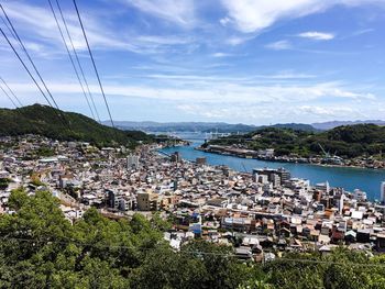 High angle view of townscape by sea against sky