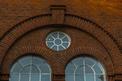 Low angle view of clock on wall of building