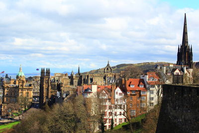 Panoramic view of buildings in town against sky