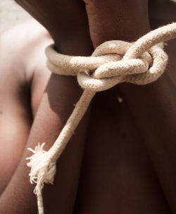 Cropped hand of person tied on a rope