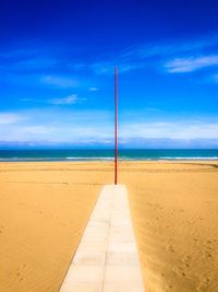 Scenic view of beach against blue sky