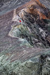 People on rock by mountain