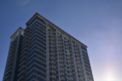 Low angle view of modern building against clear blue sky