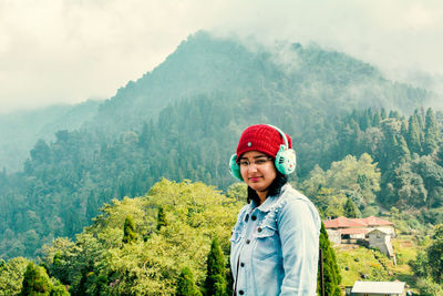 Portrait of man standing against mountain