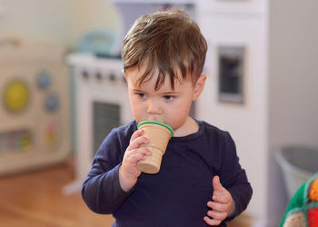 Baby boy pretending to eat icecream