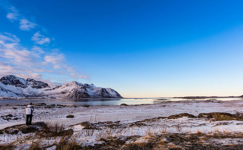 Scenic view of snowcapped mountains against blue sky