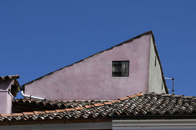 Low angle view of building against clear blue sky