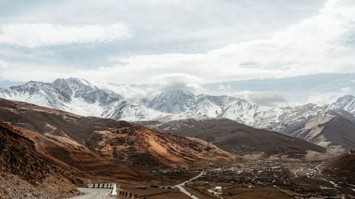 Scenic view of snow covered mountains against sky