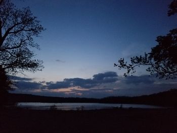 Scenic view of beach against sky at sunset