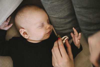 Mother giving newborn baby pacifier