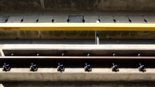 High angle view of people sitting on wall