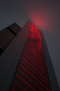 Low angle view of modern building against sky during sunset