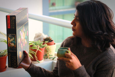 Midsection of woman drinking coffee